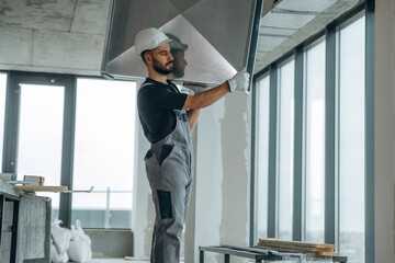 A man is renovating an unfinished room