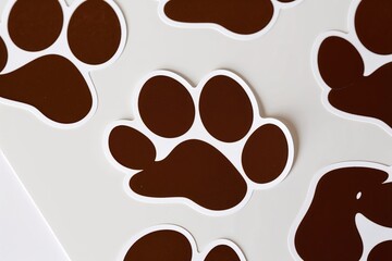 Obraz premium Brown Paw Shape Sticker Series on White Background