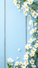 Fototapeta premium Delicate white flowers with yellow centers elegantly frame a light blue wood backdrop. Petals and leaves scattered, creating a springlike scene.