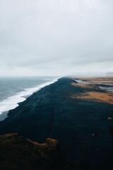Dramatic black sand beach with ocean waves
