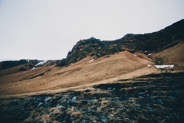 Rugged landscape with rocky hill and cloudy sky