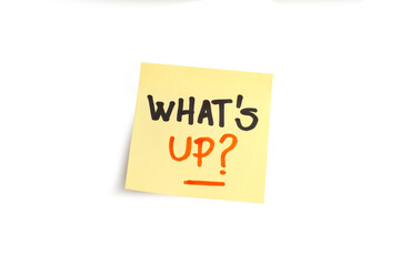 Whats up handwritten on a yellow sticky paper on a white background with copy space