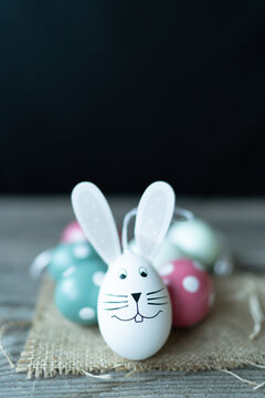 Easter bunny in front of Easter eggs