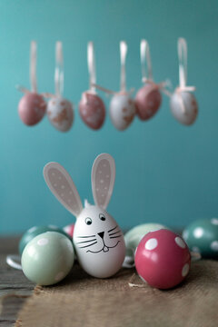 Easter bunny in front of Easter eggs