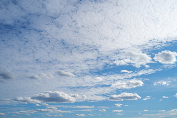 white fluffy clouds standing out against  a blue sky