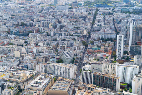 A breathtaking stock photo capturing a bird's eye view of a charming Parisian neighborhood, as seen from the top of the Eiffel Tower. The image showcases the intricate layout of street & buildings.