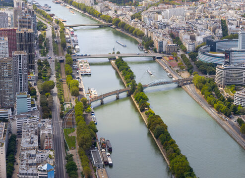 A mesmerizing stock photo offering a panoramic view of the Seine River, captured from the heights of the Eiffel Tower. The image beautifully displays the river winding through the heart of Paris.