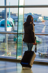 Woman waiting for a plane at airport