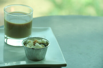 Transparent double wall glass, with black coffee, on white background. Cup with black liquid on white rotating table.