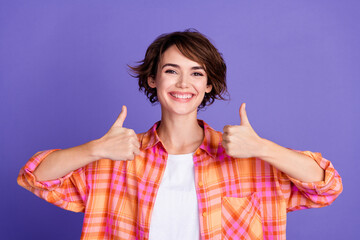 Photo of pretty young girl show thumb up wear shirt isolated on violet color background