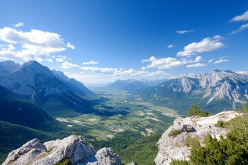 Obraz premium Panoramic view of a valley nestled between majestic mountains under a bright, sunny sky.