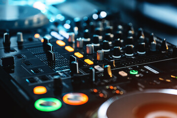 closeup of professional digital pioneer dj decks and audio mixer equipment ready for party in...
