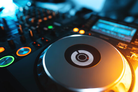 closeup of professional digital pioneer dj decks and audio mixer equipment ready for party in nightclub