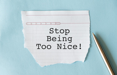 White note on wall with text STOP BEING TOO NICE - concept of self reminder to stop trying so hard...