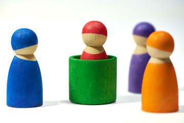 Wood, figure and studio on white background for community, diversity and teamwork with social group. Wooden icon, symbol and friendship with connection, society or abstract people together with color