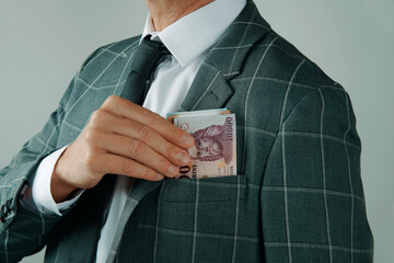 businessman taking out forints from his pocket