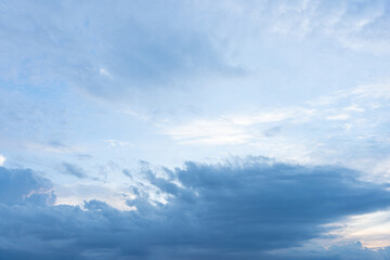 Beautiful cloudscape with fluffy white clouds drifting across a clear blue sky