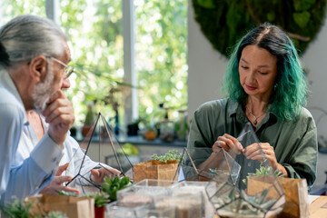 close up master class on creating compositions from plants for elderly people green-haired teacher happy old age elderly couple pleasant memories leisure time in old age
