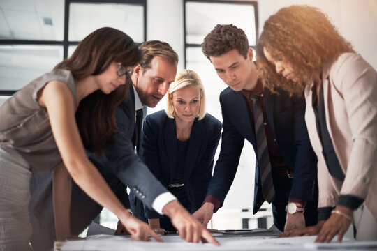 Architecture, meeting and business people in office with blueprint for planning, building design and floorplan. Construction, professional and men and women with documents for discussion and teamwork - Powered by Adobe