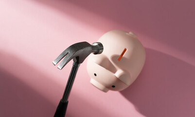 Hammer about to break a piggy bank