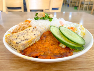 Vietnamese grilled rib broken rice, shredded pork skins, fried egg and meat patty served with fish-sauce. Flat pork ribs marinated with spices, glazed with liquid caramel, then charcoal-grilled.
