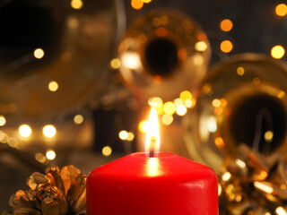 Festive Christmas decoration with one burning candle and brass instruments