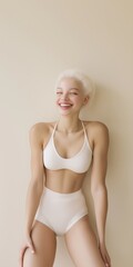 Fototapeta premium A woman is smiling and wearing a white bikini. The image has a happy and carefree mood