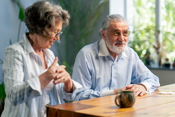 elderly people sitting at the table woman with a cup of tea happy old age elderly couple pleasant memories leisure time in old age warm feelings support in old age difficult times