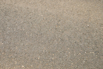 Close up of road surface - tarmac plus embedded gravel