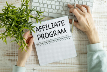 AFFILIATE PROGRAM text written on a notebook on the wooden background