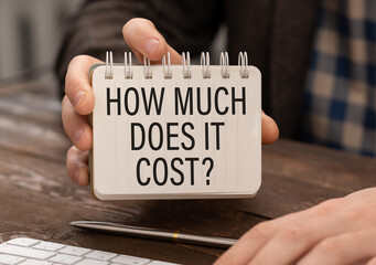How much does it cost text written in the notebook in hand.