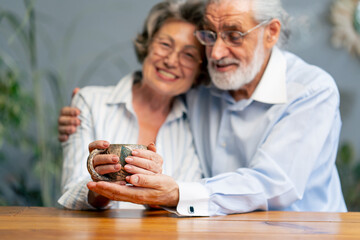 elderly people sitting at the table woman with a cup of tea happy old age elderly couple pleasant memories leisure time in old age warm feelings support in old age difficult times