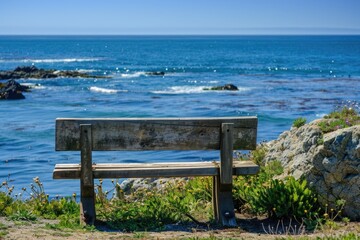 A wooden bench sits atop a lush green hillside, perfect for a picnic or relaxing in nature