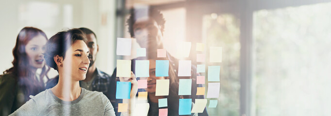 Idea, window and business people in meeting in office for brainstorming, discussion and planning. Creative company, banner and men and women with sticky notes for teamwork, research and project