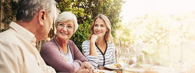 Happy, lunch and mother with senior parents in backyard for brunch, supper and eating together....
