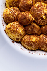 Classic italian dessert, tiramisù. An cheescake with cocoa, eggs, coffee and italian biscuits, savoiardo.