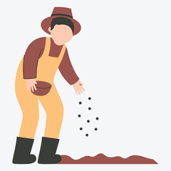 A person in overalls sowing seeds on the ground.