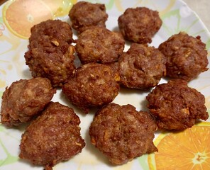 Golden brown Minced pork deep fried beef with garlic serve in white orange plate, Thai style fired pork ball
