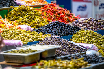 A stand with olives and other vegetables at traditional Arabic street market in Sfax, Tunisia.