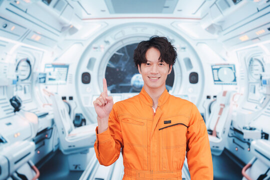 宇宙ステーションの中で働く若い男性の宇宙飛行士 - Powered by Adobe