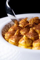 Classic italian dessert, tiramisù. An cheescake with cocoa, eggs, coffee and italian biscuits, savoiardo.