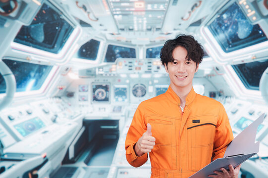 宇宙ステーションの中で働く若い男性の宇宙飛行士 - Powered by Adobe