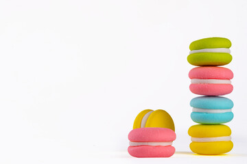 Bright colored macaroon cookies on white background, multicolor sweets dessert background