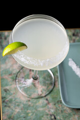 
Cocktail with salt on the glass and lime.