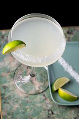 
Cocktail with salt on the glass and lime.