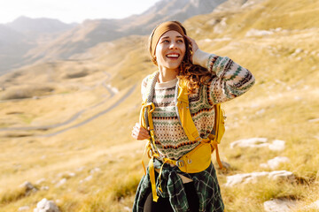 Traveler woman with backpack walking on mountain. Adventure active. Enjoy landscape.