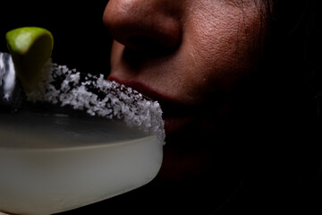 
Cocktail with salt on the glass and lime.