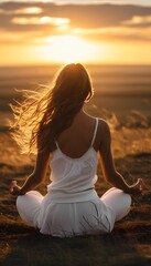 A young girl meditates at sunset
