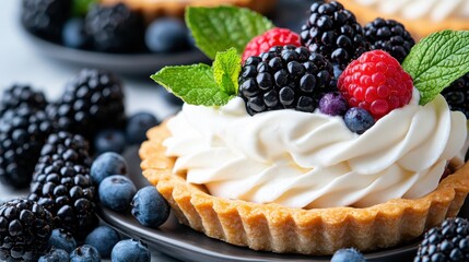 A luxurious gourmet tart brimming with ripe berries and adorned with mint leaves, offering a visually stunning and mouthwatering dessert.