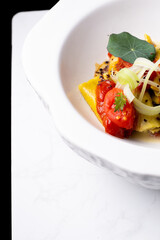 Italian pasta, ravioli, with tomato and vegetables.